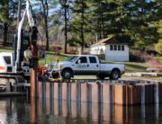 A white truck parked on top of a dock.