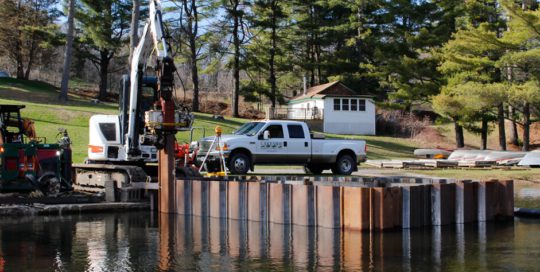 A white truck parked on top of a dock.