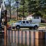 A white truck parked on top of a dock.