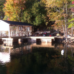 A dock with a boat in the water.