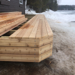 A wooden deck sitting in the middle of snow.