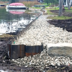 Retaining wall and riprap protect shoreline.