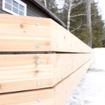 A wooden fence with snow on the ground.