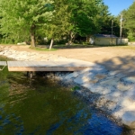 A body of water with trees and grass in the background.