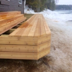 A wooden deck with snow on the ground